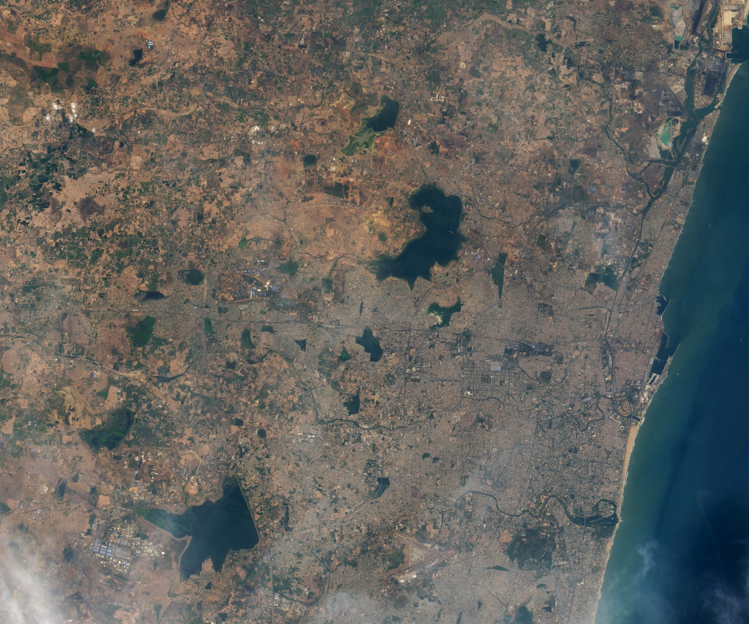 Landsat 8 OLI image of Puzhal (Red Hills) reservoir on 31 May 2018, showing the reservoir at near-full capacity. Dark blue water fills the bowl; the surrounding land is green-brown.