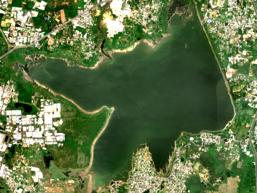 Chembarambakkam reservoir near Chennai seen from space in natural colour, full to its shorelines, with town and farmland around it.